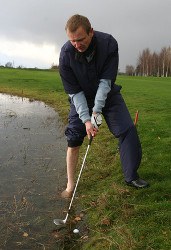 Golfer strikes a golf shot